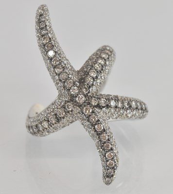 Lot 1217 - A white metal diamond set 'starfish' ring, set...