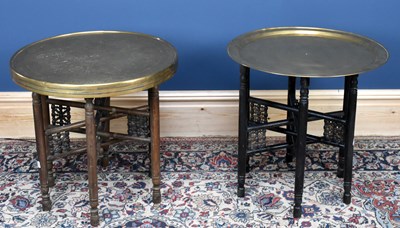 Lot 2920 - Two brass topped Benares tables on folding bases.