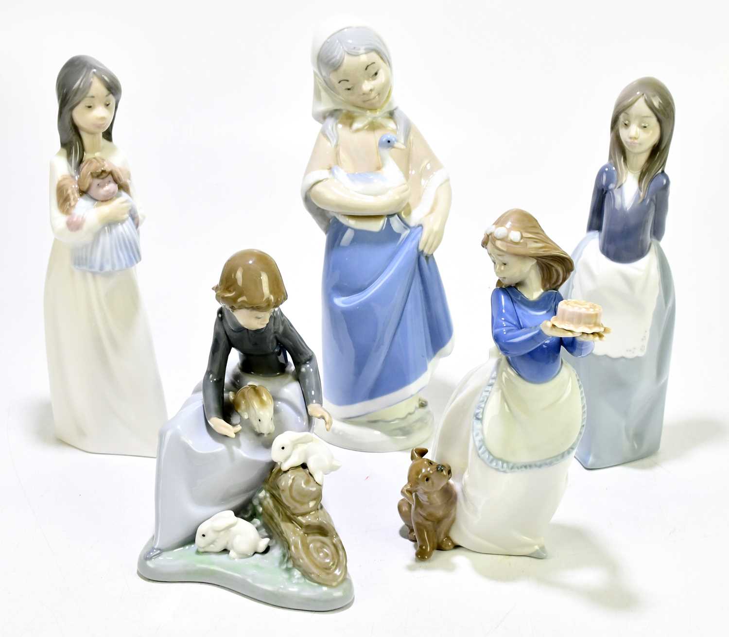 Lot 522 - NAO; four assorted figures to include a girl...