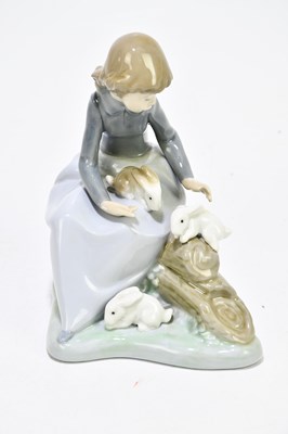 Lot 522 - NAO; four assorted figures to include a girl...