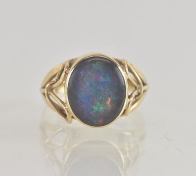 Lot 1261 - A 9ct gold opal set ring, the bezel set oval...