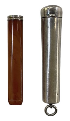 Lot 1151 - An amber cigar holder with silver rim, in a...