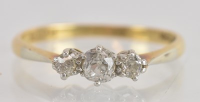 Lot 1249 - An 18ct yellow gold and platinum diamond three...