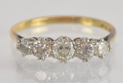 Lot 1241 - An 18ct yellow gold and platinum diamond five...