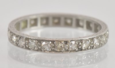 Lot 1231 - A white metal diamond set eternity ring, set...
