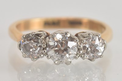 Lot 1225 - An 18ct yellow gold diamond set three stone...