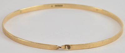 Lot 1514 - A 9ct yellow gold bangle, diameter 7cm, approx...