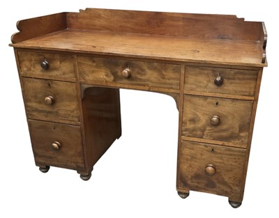 Lot 10 - A Victorian mahogany gallery back kneehole...