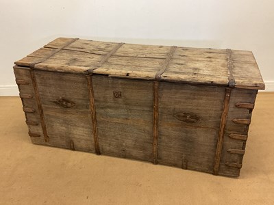 Lot 410 - A rustic strap bound oak coffer with twin...