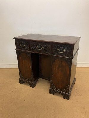 Lot 399 - An Edwardian mahogany fret carved kneehole...