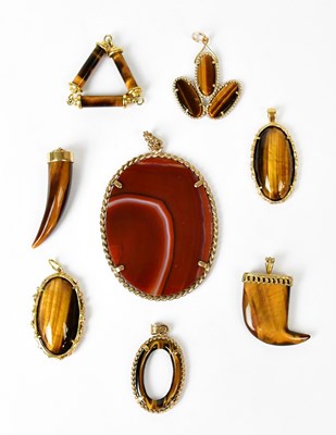 Lot 866 - A collection of tiger's eye pendants of...