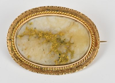 Lot 70 - A yellow metal oval brooch, set with central...