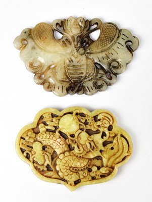 Lot 377 - Two carved jade pendants, one decorated with a...
