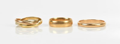 Lot 432 - A yellow metal wedding band, size S, a further...