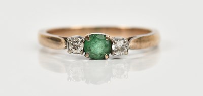 Lot 467 - A yellow metal diamond and emerald set three...
