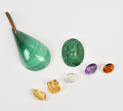 Lot 205 - Five loose cut gemstones, including an oval...