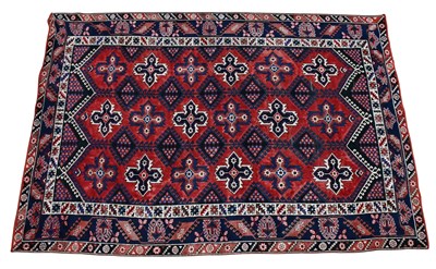 Lot 1248 - A red ground Caucasian carpet, with central...