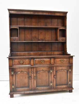 Lot 1040 - A reproduction oak dresser, with three drawers...