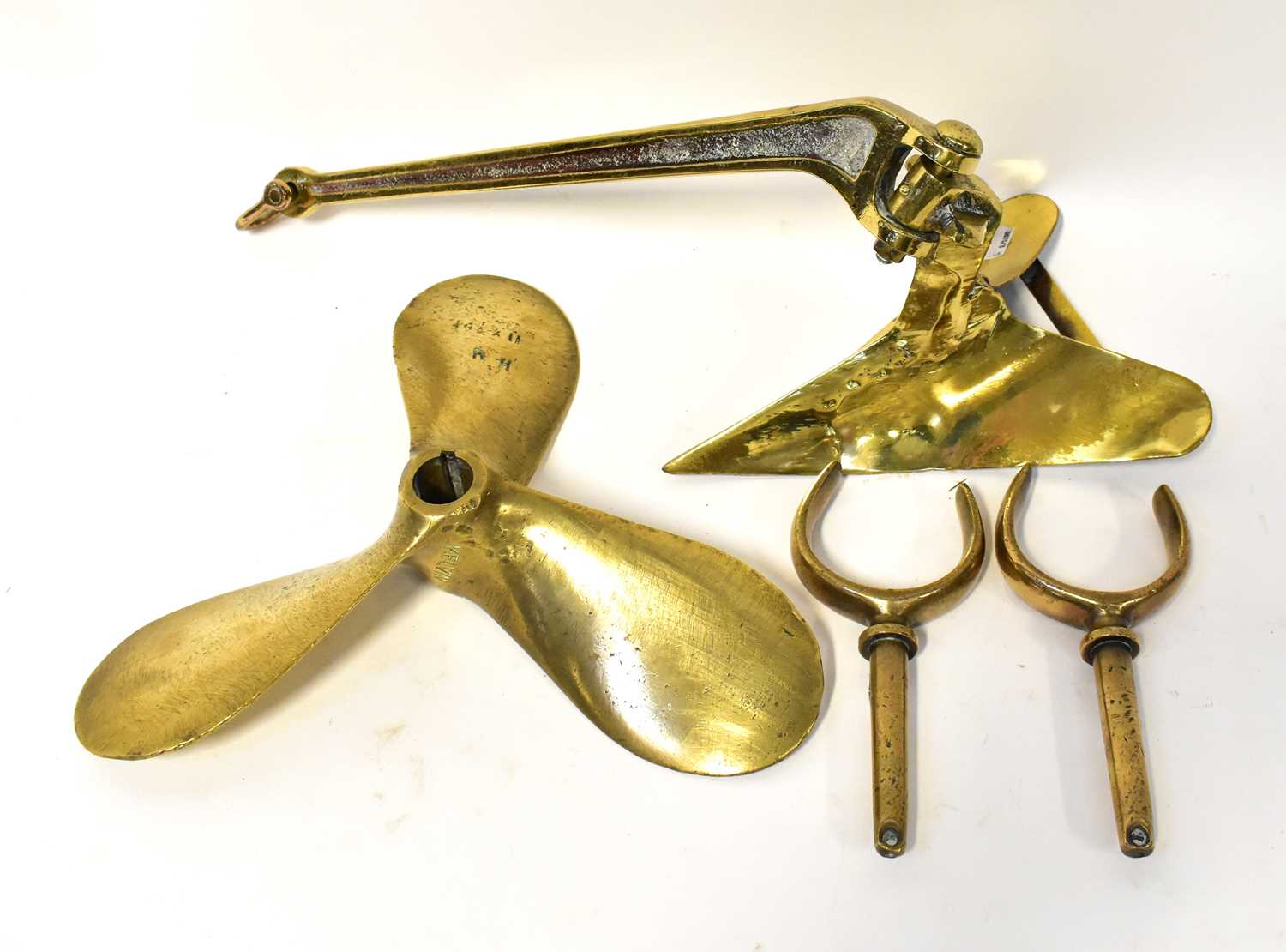 Lot 266 - A polished brass anchor with hinged arm, a...