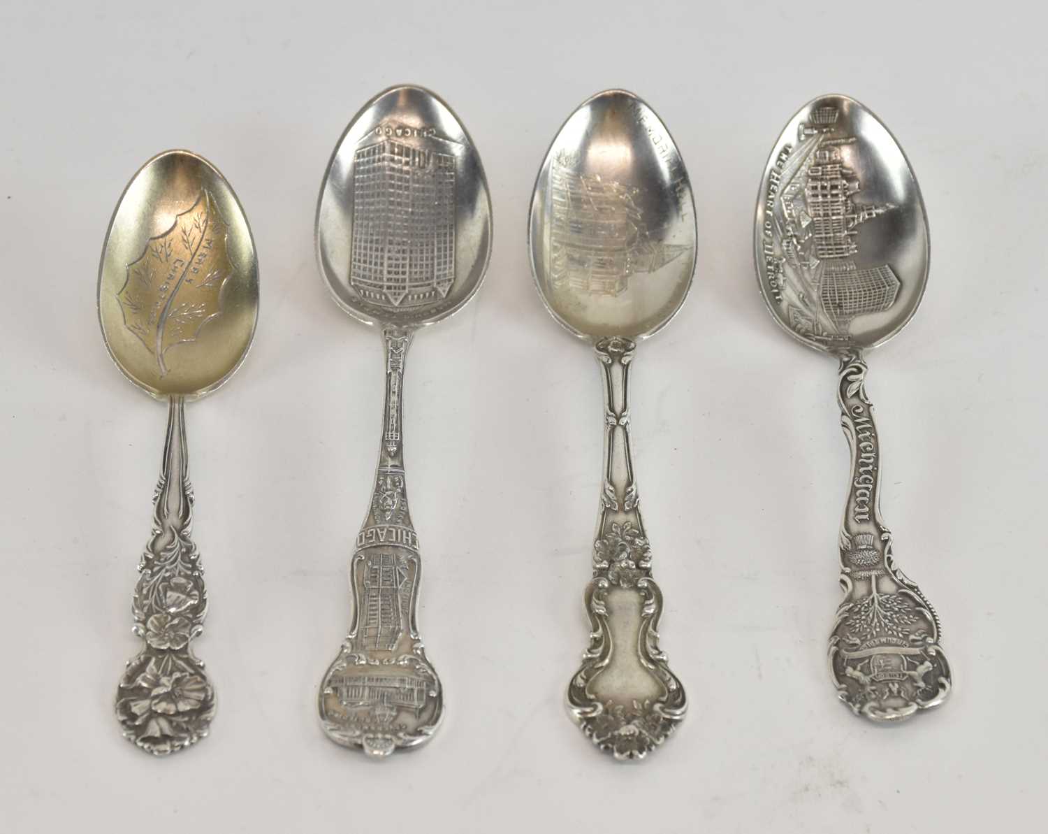 Lot 1173 - Four sterling silver souvenir spoons, one for...