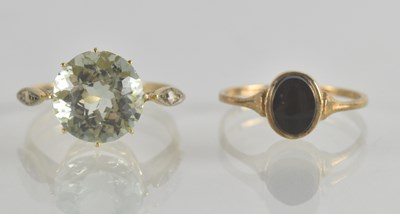 Lot 1305 - Two 9ct gold rings, one with claw set cut blue...