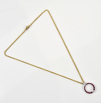 Lot 229 - An 18ct white gold circular synthetic ruby and...
