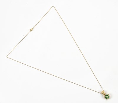 Lot 312 - A yellow metal emerald and diamond pendant,...