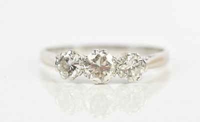 Lot 494 - A white metal diamond three stone dress ring,...