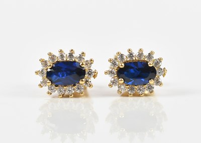 Lot 202 - A pair of yellow metal ear studs set with oval...