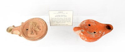 Lot 221 - Two Roman finely moulded redware oil lamps...