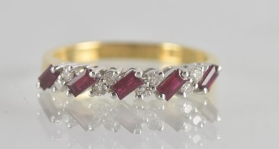 Lot 1312 - An 18ct gold diamond and ruby set half...