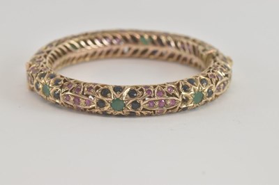 Lot 1496 - A vintage gold coloured metal hinged bracelet,...
