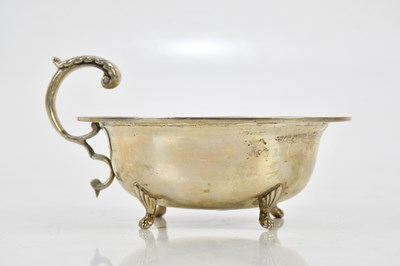 Lot 2351 - A white metal sauceboat of circular form, with...