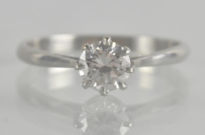 Lot 1233 - A diamond solitaire ring, the prong set...
