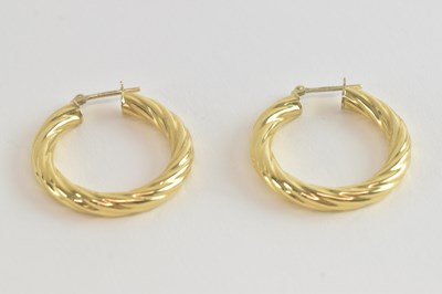 Lot 1449 - A pair of 18ct gold twist hoop earrings,...