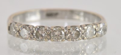 Lot 1268 - An 18ct white gold half eternity ring set with...