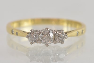 Lot 1269 - An 18ct yellow gold three stone diamond set...