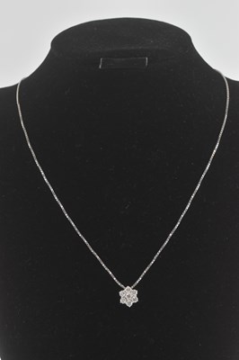 Lot 1380 - An 18ct gold floral diamond pendant set with...