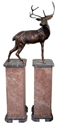 Lot 612 - A modern bronzed white metal figure of a deer,...