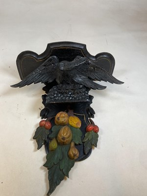 Lot 49 - A painted and carved wall bracket set with an...