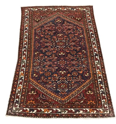 Lot 91 - A vintage red ground Persian carpet, decorated...