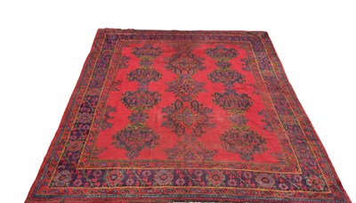 Lot 87 - A large antique Oushak carpet, with geometric...