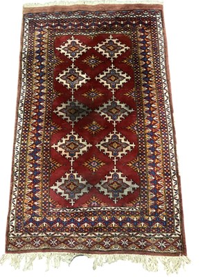 Lot 92 - A Persian style red ground hand knotted...