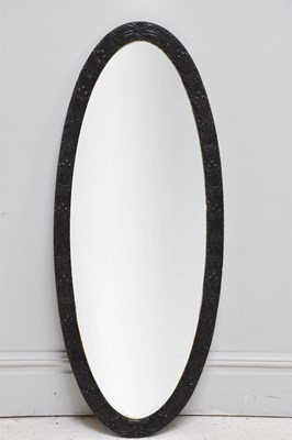 Lot 175 - An early 20th century carved oval wall mirror,...