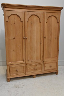 Lot 1027 - A pine wardrobe, with moulded cornice above...