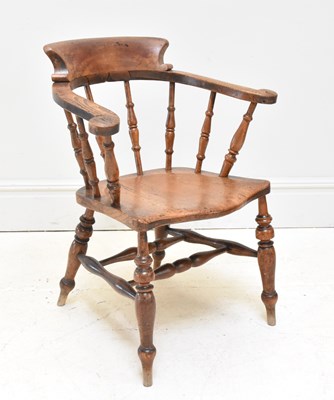 Lot 1124 - A 19th century elm seated smoker's bow back...