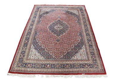 Lot 1260 - A large decorative rug with stylised...