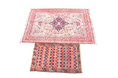Lot 1261 - A red ground Eastern style rug with geometric...
