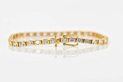 Lot 55 - A yellow metal tennis bracelet, set with...