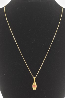 Lot 1397 - A yellow metal Egyptian style pendant,...